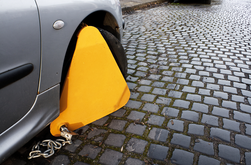 Car with clamp on to immobilize movement as a penalty to an offence such as no tax