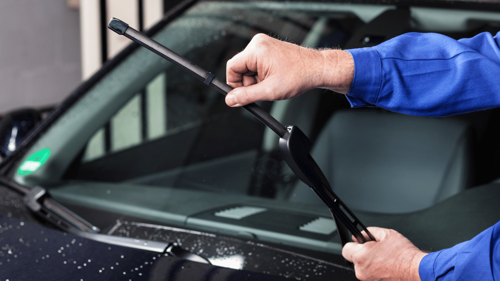 Person checking tyres and lights on an electric car